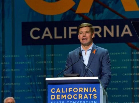 Man speaking at California Democrats State Convention podium.